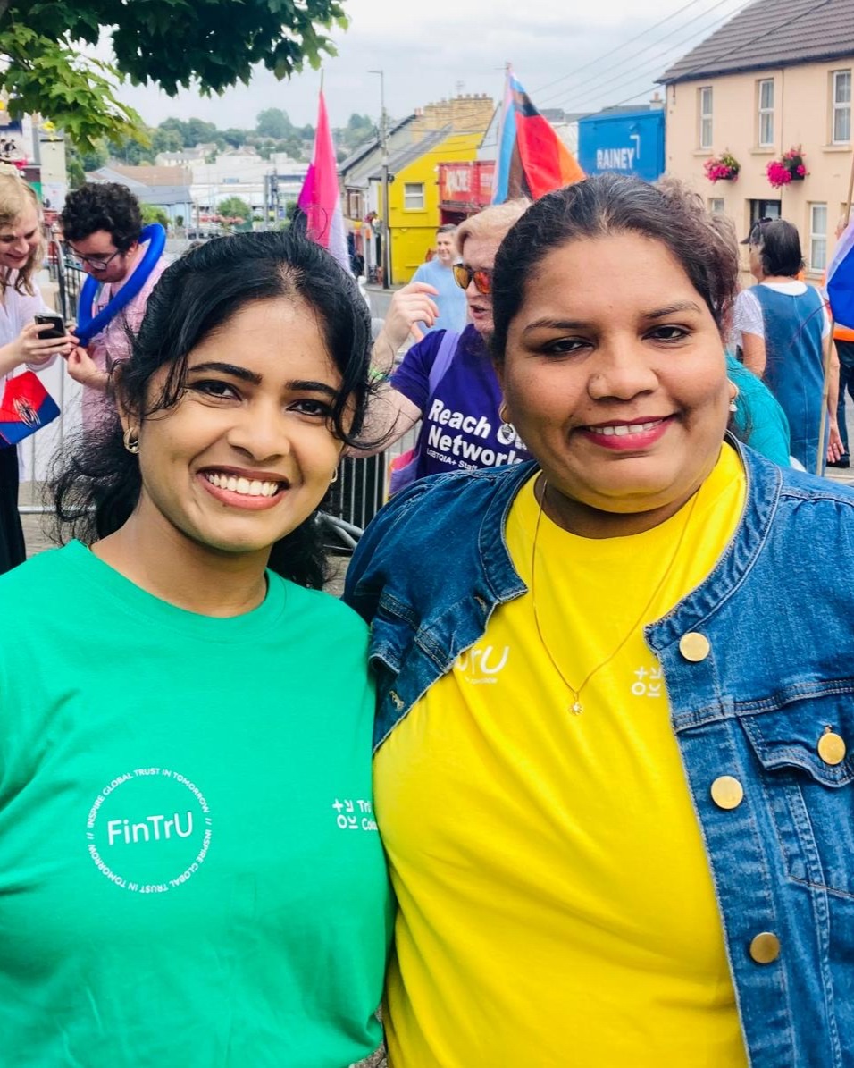 Two women, one in a green t shirt and one in a yellow t shirt