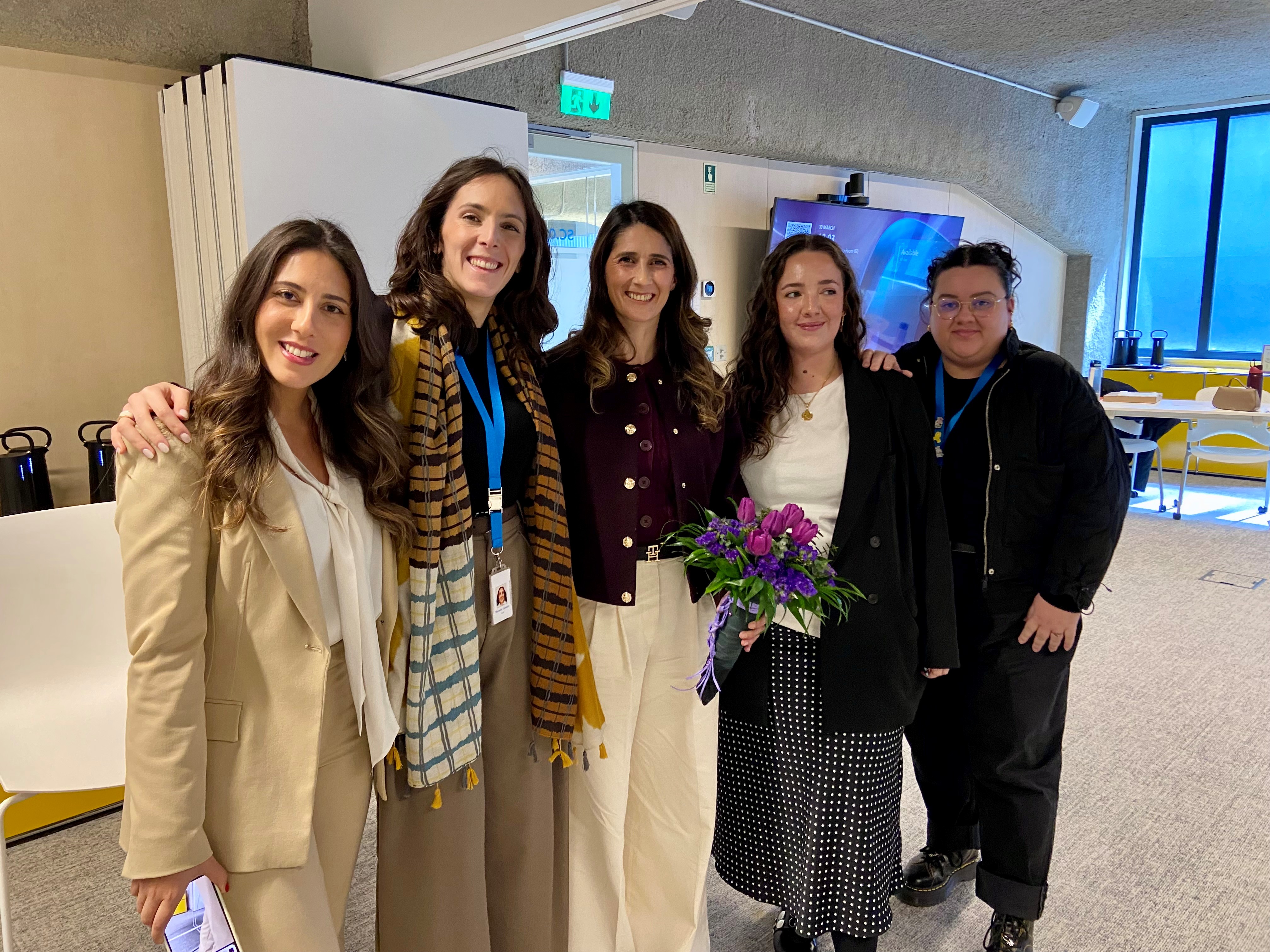 Five women smiling standing together