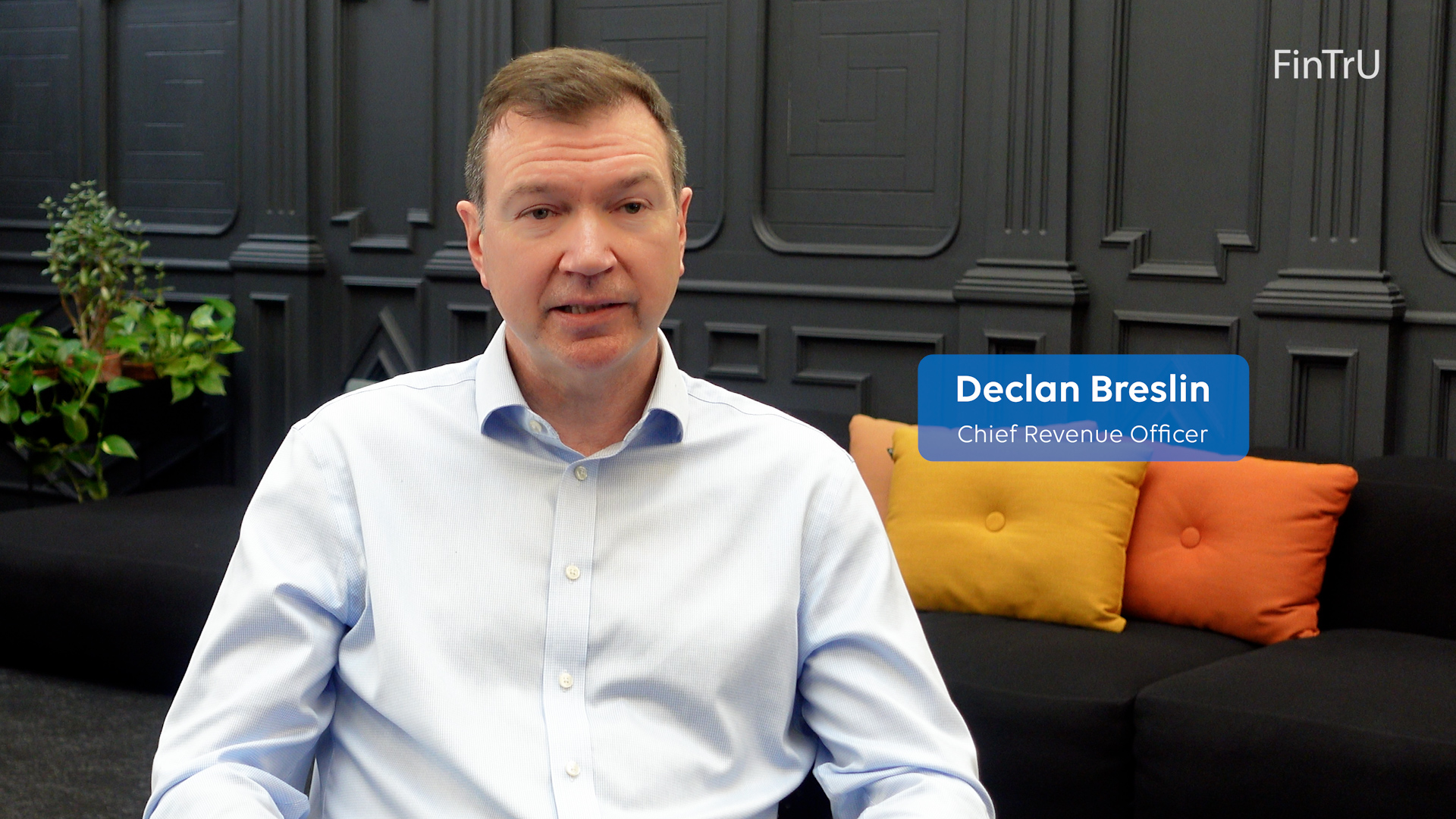 Declan Breslin in front of a dark background