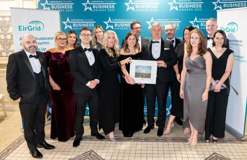 14 people standing with an award
